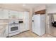 Functional kitchen featuring white appliances and tiled floors at 1004 S Ironwood Dr, Apache Junction, AZ 85120