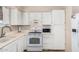 Functional kitchen featuring white appliances and tiled floors at 1004 S Ironwood Dr, Apache Junction, AZ 85120