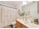 Bathroom featuring modern fixtures, decorative mirror, and stylish shower curtain at 10212 E Betony Dr, Scottsdale, AZ 85255