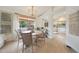 Dining area with wood table, wicker chairs, and view to kitchen with white cabinets at 10212 E Betony Dr, Scottsdale, AZ 85255