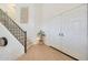 Bright foyer featuring light wood floors, staircase, and double front doors at 10212 E Betony Dr, Scottsdale, AZ 85255