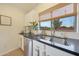 Close-up of kitchen sink with stainless steel appliances and a view of the outdoors at 10212 E Betony Dr, Scottsdale, AZ 85255