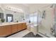 Primary bathroom with dual vanities, soaking tub, and glass-enclosed shower at 10212 E Betony Dr, Scottsdale, AZ 85255