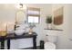 Stylish powder room featuring a unique vanity, decorative mirror, and modern fixtures at 10212 E Betony Dr, Scottsdale, AZ 85255