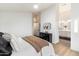 Bright bedroom featuring neutral decor, ensuite bathroom access, wood floors and contemporary decor at 10215 E Hillery Dr, Scottsdale, AZ 85255