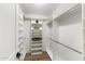 A spacious walk-in closet featuring custom shelving and a hanging rod at 10215 E Hillery Dr, Scottsdale, AZ 85255