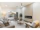 Bright living room with a linear fireplace, sliding glass doors and neutral color palette at 10215 E Hillery Dr, Scottsdale, AZ 85255