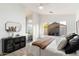 A serene bedroom with a large window, a sleek bathroom, and a decorative cabinet at 10215 E Hillery Dr, Scottsdale, AZ 85255