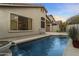 Inviting backyard pool featuring a calming water feature and meticulously maintained landscaping at 10215 E Hillery Dr, Scottsdale, AZ 85255