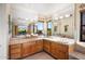 Bathroom featuring dual vanities with tile countertops and a view to the backyard at 10301 N 128Th St, Scottsdale, AZ 85259