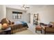 Cozy bedroom featuring a ceiling fan, neutral tones, and a comfortable armchair at 10301 N 128Th St, Scottsdale, AZ 85259