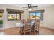 Dining room with tile floors, a ceiling fan, and views of the backyard and desert landscape at 10301 N 128Th St, Scottsdale, AZ 85259