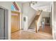 Bright foyer with tile flooring, stairs to the second floor, and a custom stained glass door at 10301 N 128Th St, Scottsdale, AZ 85259