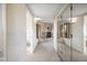 Hallway featuring tiled fireplace, view to shower, and mirrored wall with window at 10301 N 128Th St, Scottsdale, AZ 85259