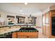 Bright kitchen with tile countertops, stainless appliances, and an open view of the breakfast area at 10301 N 128Th St, Scottsdale, AZ 85259