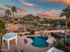 Aerial view of the pool, tennis courts, and desert landscaping with mountain views at 10301 N 128Th St, Scottsdale, AZ 85259