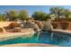 Beautiful pool includes a rock waterfall feature and a basketball hoop for added fun at 10301 N 128Th St, Scottsdale, AZ 85259