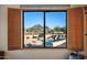 Window view of pool, mountain and desert landscape with open shutters at 10301 N 128Th St, Scottsdale, AZ 85259