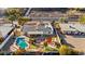 Expansive aerial view of the backyard featuring a swimming pool, outdoor kitchen, desert landscaping, and solar panels at 1031 W Indian Hills Pl, Phoenix, AZ 85023