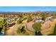 Expansive aerial view of homes near a well maintained lush green golf course and distant mountain views at 1031 W Indian Hills Pl, Phoenix, AZ 85023