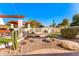 Secluded backyard retreat with a bridge, native desert plants, a fireplace, and outdoor seating at 1031 W Indian Hills Pl, Phoenix, AZ 85023