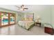 Bedroom with access to the pool area, featuring tile floors and soft green walls at 1031 W Indian Hills Pl, Phoenix, AZ 85023