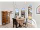 Dining area with large arched windows, wood-look tile floor and decorative furnishings at 1031 W Indian Hills Pl, Phoenix, AZ 85023