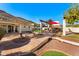 Backyard patio with a bridge, BBQ fireplace, outdoor seating, and lemon tree with fruit at 1031 W Indian Hills Pl, Phoenix, AZ 85023