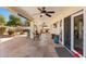 Spacious covered patio with outdoor kitchen, ceiling fans, and stone flooring overlooking the pool at 1031 W Indian Hills Pl, Phoenix, AZ 85023