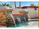 Luxury pool featuring decorative stone waterfall feature and resort-style landscaping at 1031 W Indian Hills Pl, Phoenix, AZ 85023