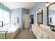 Bathroom featuring walk-in shower, soaking tub and double sink vanity at 1054 W Park Ave, Gilbert, AZ 85233