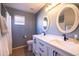 Bathroom with double sinks, white cabinets, and bronze fixtures at 1054 W Park Ave, Gilbert, AZ 85233