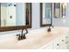 Bathroom featuring double sinks with bronze fixtures and framed mirrors at 1054 W Park Ave, Gilbert, AZ 85233