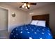 Inviting bedroom with ceiling fan and a blue star themed comforter at 1054 W Park Ave, Gilbert, AZ 85233