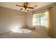 Bedroom with a window, ceiling fan and carpeted floor at 1054 W Park Ave, Gilbert, AZ 85233