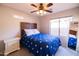 Cozy bedroom with ceiling fan, window, and a patriotic theme bedspread at 1054 W Park Ave, Gilbert, AZ 85233