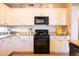 Well-lit kitchen featuring white cabinets, stainless steel appliances, granite counters, and tile floors at 1054 W Park Ave, Gilbert, AZ 85233