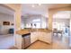 Bright kitchen with stainless steel dishwasher, granite countertops, and a view of the dining area at 1054 W Park Ave, Gilbert, AZ 85233