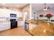 Bright kitchen with stainless steel appliances, granite countertops, and a breakfast bar overlooking the living area at 1054 W Park Ave, Gilbert, AZ 85233