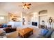 Inviting living room with vaulted ceilings, open to kitchen, featuring ceiling fan and comfortable furnishings at 1054 W Park Ave, Gilbert, AZ 85233