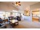 Open-concept living room with vaulted ceilings, ceiling fan, comfortable seating, and seamless flow to the kitchen at 1054 W Park Ave, Gilbert, AZ 85233