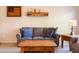 Comfortable living room with a large couch, wooden coffee table, and neutral color palette at 1054 W Park Ave, Gilbert, AZ 85233