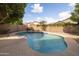 Private backyard pool featuring cool blue tile accents and rock feature, surrounded by low-maintenance desert landscaping at 1054 W Park Ave, Gilbert, AZ 85233