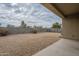 Backyard showcasing low-maintenance landscaping, block fence, and covered patio at 10705 E Sunflower Ct, Florence, AZ 85132