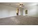 A large bedroom with neutral walls, carpet, and a ceiling fan at 10705 E Sunflower Ct, Florence, AZ 85132