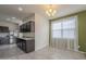 Bright kitchen and breakfast nook with tiled floors, stainless steel appliances, and modern chandelier at 10705 E Sunflower Ct, Florence, AZ 85132