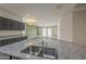 Open-concept kitchen with stainless sink, granite countertops, and views to the living space at 10705 E Sunflower Ct, Florence, AZ 85132