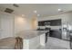 Bright kitchen featuring stainless steel appliances, an island with bar seating, and ample cabinet space at 10705 E Sunflower Ct, Florence, AZ 85132