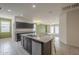 Spacious kitchen with island and granite countertops, adjoining to the living room at 10705 E Sunflower Ct, Florence, AZ 85132