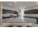 Modern kitchen featuring a granite island with seating, stainless appliances, and dark wood cabinets at 10705 E Sunflower Ct, Florence, AZ 85132